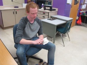 Another student demonstrates his 3D printed frog, which resonates sounding like a 'ribbet' when a stick is rubbed on it's back.